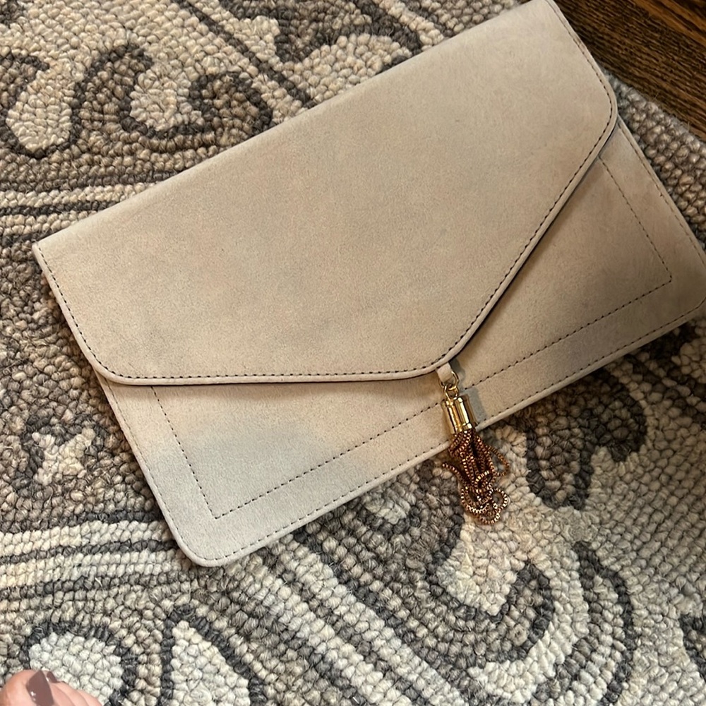 Light grey clutch with gold tassel